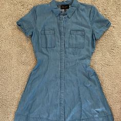 Nwot - Never Worn Beautiful A-Line Silhouette Denim Dress! Button Up Front With Denim Flap Covering The Buttons. Has 2 Side Pockets! Super Soft Material. Size M 100% Lyocell Approximate Measurements: Waist 28” Length ~33” Comment Any Questions And Feel Free To Make An Offer! Denim Blue Cotton Button-up Dress, Button-up Denim Blue Cotton Dress, Short Sleeve Chambray Dresses With Pockets, Chambray Short Sleeve Dress With Pockets, Denim Blue Cotton Dresses With Buttoned Pockets, Denim Blue Chambray Short Sleeve Dress, Button-up Denim Dress With Pockets, Cotton Button-up Denim Dress With Pockets, Button-up Cotton Denim Dress With Pockets