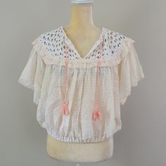 Free People Allora Allora Top Size Large Ruffled Crochet Neckline With Tassels Cropped Styling With Elastic Waist Short Flutter Sleeves Lightweight 100% Cotton Fabric 22" Across Chest, 20" Length; Measurements Are Flat-Lay Summer V-neck Top With Tassels, Summer V-neck Tops With Tassels, Bohemian Spring Lace Top With Short Sleeves, Spring Festival Lace Top With Crochet Trim, Bohemian Short Sleeve Lace Top For Spring, Festival Beige Tops With Crochet Trim, Summer Beach Blouse With Back Tassel Tie-up, Summer Beach Peasant Top With Ruffles, Summer Ruffle Sleeve Tops With Lace Trim