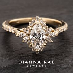 a yellow gold ring with an oval cut diamond surrounded by smaller round diamonds on the band