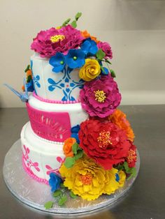 a three tiered cake decorated with flowers