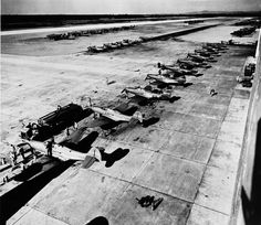 black and white photograph of airplanes parked on the tarmac