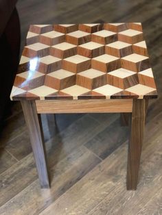 a small wooden table sitting on top of a hard wood floor