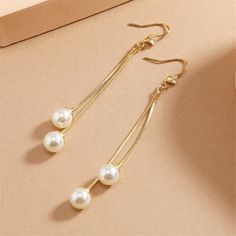 Drop earrings featuring a dangly tassel motif created with shining 18k gold-plated and accented with sparkling cubic zirconia and pearls. 0.31" W x 2.76" L 18k gold-plated copper / cubic zirconia / pearl Tassel Drop Earrings, Bridal Accessories, Cubic Zirconia, Tassels, 18k Gold, Gold Plate, Gift Card, Sparkle, Copper