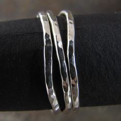 These delicate looking stacking rings are made of non-tarnish argentium sterling silver. Each one is hand made by me and they are made to order. They will never look exactly like the picture, but close. Almost always, I get all my orders out the day following your order. Individually the rings measure about 1.5mm wide. they are also available unwonkified in a set of 3: http://www.etsy.com/listing/81059502/skinny-hammered-silver-stack-rings-set or 5 - http://www.etsy.com/listing/81059192/skinny-h Handmade Stackable Toe Rings For Everyday, Handmade Everyday Stackable Toe Rings, Everyday Hand Forged Sterling Silver Stackable Rings, Dainty Hand Forged Sterling Silver Stackable Rings, Simple Handmade Adjustable Stackable Rings, Handmade Adjustable Simple Stackable Rings, Handmade Simple Adjustable Stackable Rings, Handmade Silver Minimalist Stackable Rings, Handmade Minimalist Silver Stackable Rings