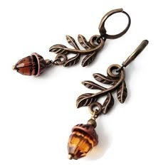 Nature-inspired in earthy colors, these adorable antique brass leaf and acorn earrings are the perfect addition to your Autumn jewelry collection. Light or dark brown exotic bridesmaid accessory with a little sparkle for a barn or garden Fall wedding. The acorn is a symbol of growth and unlimited potential. Whether you're looking for growth, perseverance, or stability, the acorn symbolizes it all. All the wonder in a mighty oak grows from a single acorn. Cute just out-of-the-forest acorn earring Dark Cottagecore Jewelry, Nature Accessories, Forest Earrings, Autumn Accessories, Acorn Jewelry, Acorn Earrings, Autumn Earrings, Autumn Jewelry, Earrings Nature