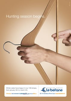 a poster with two hands holding a wooden hanger