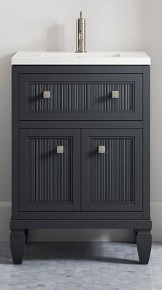 a bathroom vanity with two drawers and a white counter top in front of a wall