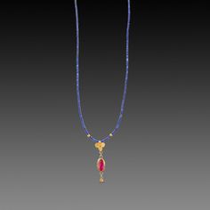 A vibrant rose cut ruby glows in warm 22k gold, and is suspended from a 22k gold trio, and accented with a tiny gold drop. A delicate strand of the most vibrant lapis beads complete this striking yet extremely delicate piece. Pendant, including trio, ruby and tiny gold drop, measures approximately 1 inch in length. 14k gold clasp. Matte finish. Gold Ruby Necklace Fine Jewelry, Gold Jeweled Ruby Necklace, Gold Ruby Necklaces With Gemstone Accents, Gold Ruby Necklaces With Polished Beads, Yellow Gold Ruby Necklace With Polished Finish, Lapis Necklace, Diy Jewelry Necklace, Ancient Jewelry, Beaded Jewelry Patterns