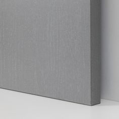 a close up view of a gray canvas on a white surface