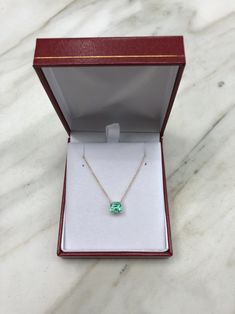 Featured here is a 1.32-carat stunning, Colombian emerald necklace in fine 14K yellow gold. Displayed in the center is a medium-light green emerald with incredible crystal clarity, accented by a simple four-prong gold mount, allowing for the emerald to be shown in full view. The earth mined, green Colombian emerald has a desirable lush green color with excellent qualities. An 18 inch is attached to the emerald pendant. This necklace is ideal for everyday use and is the perfect accessory to any o Emerald Diamond Necklace For Formal Occasions, Formal Emerald Necklace With Diamond Cut, Formal Emerald Necklaces With Diamond Cut, Formal Green Gemstone Diamond Necklace, 14k Gold Emerald Cut Solitaire Necklace, Emerald Cut Solitaire Necklace In 14k Gold, Elegant Green Solitaire Necklace With Birthstone, Formal Cushion Cut Gemstone Necklace, 14k Gold Emerald Cut Fine Jewelry Necklace