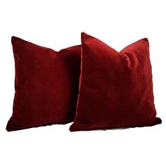 two red pillows sitting on top of each other