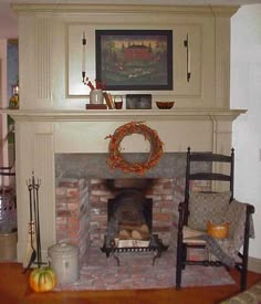 a living room filled with furniture and a fire place covered in a wreath on top of a mantle