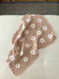 "Handmade baby blanket in my daisy flower style. This yarn is 100% cotton and super soft but has a night weight to it. Each item is made to order. Please see below for size measurements. See photos for base color options. Blankets sizes:  Lovey: 11x11' (4 squares) Cuddle: 16x16\" (9 squares) Receiving: 30x21\" (24 squares) Check out my Instagram sales codes and exclusive ready to ship items: @BethanysTreasures Or Like my Facebook page: www.facebook.com/BethanysTreasuresBoutique" Daisy Blanket, Daisy Baby Blanket, Daisy Square Crochet Blanket, Daisyfarm Crochet Baby Blanket, 70s Daisy Crochet Blanket, Heirloom Baby Blankets, Instagram Sales, Handmade Baby Blankets, Flower Blanket