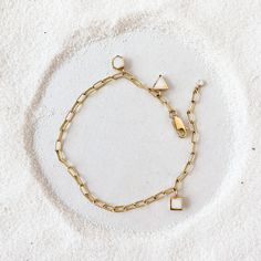 Introducing our Paperclip Charm Bracelet, the embodiment of style and personality. This substantial bracelet boasts a chunky chain design crafted from premium 14-karat gold-fill, making it both opulent and durable. It features a charm addition that reveals your unique personality. Meant to be worn daily and effortlessly stacked with your other favorites, it's the ultimate expression of your style. Choose one charm in your favorite shape and color. Add more to customize and make it as full as you Gold-tone Brass Bracelet With Solid Link Construction, Modern Charms Bracelets, Metal Charm Bracelet With Tarnish-resistant Rectangular Links, Gold-tone Brass Bracelets With Solid Link, Everyday Gold Chain Bracelet With Oyster Design, Minimalist Gold-tone Jewelry With Solid Links, Everyday Yellow Gold Chain Bracelet With Oyster Detail, Everyday Yellow Gold Oyster Chain Bracelet, Modern White Chain Jewelry