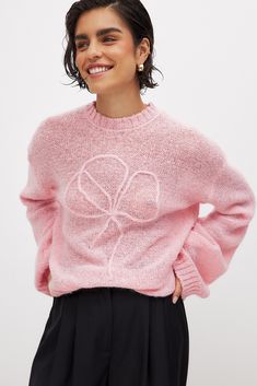 This sweater features an oversized fit and a stretchy, soft, loose knit material. It has a round neckline and ribbed hems. Oversized Crew Neck Cropped Sweater For Spring, Trendy Cropped Soft Knit Sweater With Crew Neck, Trendy Cropped Sweater With Crew Neck In Soft Knit, Trendy Crew Neck Cropped Sweater In Soft Knit, Oversized Crew Neck Knit Top, Chic Oversized Pink Sweater, Oversized Crew Neck Knit Top With Ribbed Cuffs, Oversized Textured Knit Top With Crew Neck, Oversized Textured Knit Crew Neck Top