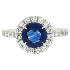 an oval blue sapphire and diamond ring with white diamonds around it, set in 18k white gold