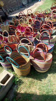 many baskets are lined up on the grass