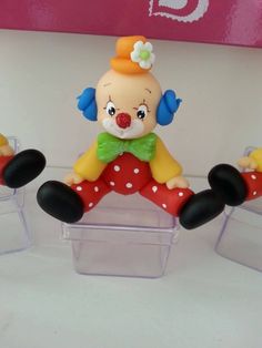 a toy clown sitting on top of a plastic chair