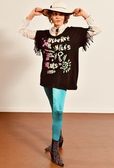 "Beverly Hills Blues/ Vintage Black T-Shirt/ Black Fringe T-Shirt/ Fringe T-Shirt/ Beverly Hills T-Shirt/ Neon T-Shirt/ Size M Super fun vintage t-shirt in excellent pre-worn condition. Neon letter graphic in neon. Fringe sleeves! Model is 5'4\" and a size 4 for scale. Please see exact measurements below. Item measured while flat, double where applicable, i.e. waist, hips. Shoulder to shoulder Armpit to armpit Waist Sleeve length T-shirt length 100% cotton." Alternative Black Stretch T-shirt, Black T-shirt With Text Print For Alternative Fashion, Punk Style Crew Neck Stretch T-shirt, Punk Style Stretch T-shirt With Crew Neck, Oversized Crew Neck T-shirt For Alternative Fashion, Stretch Graphic Print Top For Alternative Fashion, Stretch Tops With Graphic Print For Alternative Fashion, Blue Cotton Punk Top, Trendy Alternative Fashion T-shirt With Text Print