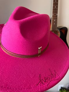 Make a statement with the Howdy hat! This hot pink, dolly parton inspired style is the perfect way to introduce some western flair into your wardrobe. The unique howdy detail will make sure you stand out in a crowd! The hot pink howdy hat is the perfect addition to your western wardrobe Pink Fitted Brimmed Fedora, Fitted Pink Brimmed Fedora, Pink Fedora Felt Hat For Kentucky Derby, Pink Felt Hat With Short Brim For Country Events, Pink Western Felt Hat With Curved Brim, Pink Short Brim Felt Hat For Country Events, Pink Western Style Felt Hat With Curved Brim, Pink Fedora For Kentucky Derby, Adjustable Pink Hat For Fall