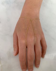 "DETAILS - Crafted with pure solid 14k gold - Finger loop is approximately 7.5\" - Bracelet is adjustable up to 7\" - Made in New York VARIATIONS If you require any variation of this style, feel free to message us. We will do our best to accommodate you. Additional costs may apply depending on the variation. POLICY This item is made to order. Made to order items are final sale and sometimes require additional production time. However, our goal is to give you something you love. If you have any q Adjustable Dainty 14k Gold Bracelet, Adjustable 14k Gold Bangle Bracelet, Adjustable 14k Gold Tarnish-resistant Bracelet, Adjustable Chain 14k Gold Bangle, Adjustable 14k Gold Bracelet, Tarnish Resistant, 14k Gold Bangle Bracelet With Adjustable Chain, Adjustable 14k Gold Bracelets Fine Jewelry, Adjustable 14k Gold Modern Jewelry, Adjustable 14k Gold Bracelets For Fine Jewelry