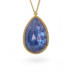 Tanzanite necklace on white Elegant Faceted Sapphire Necklaces, Elegant Sapphire Faceted Necklace, Elegant Faceted Sapphire Necklace, Gold Teardrop Sapphire Necklace, Teardrop Tanzanite Jewelry In Yellow Gold, Yellow Gold Briolette Sapphire Necklaces, Elegant Teardrop Necklace With Large Stone, Gold Tanzanite Teardrop Jewelry, Gold Tanzanite Jewelry With Faceted Design