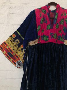 "A gorgeous, traditional Afghani Kutchi dress made by hand. Me asurements are 20\" across the chest. 48\" from mid shoulder to the bottom of the piece. 19 1/2\" long from shoulder to wrist." Bohemian Dress With Embroidered Neckline And Traditional Drape, Traditional Dress With Embroidered Neckline And Drape, Traditional Dress With Embroidered Neckline, Folk Dresses With Intricate Embroidery In Traditional Drape, Folk Style Dresses With Intricate Embroidery, Folk Style Dress With Embroidered Border For Festivals, Folk Dresses With Embroidered Border For Festivals, Transitional Multicolor Embroidered Dresses, Transitional Season Embroidered Multicolor Dresses