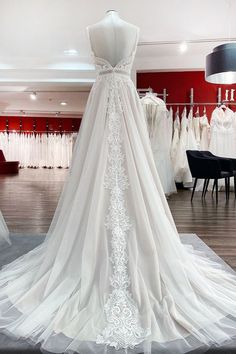 a white wedding dress on display in a store