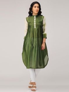 An olive green chanderi pintuck front placket tunic with 3/4th sleeves in shibori. Features: Front placket kurta with 3/4th shibori sleeves Shell - pure cotton silk fabric Pintuck detailing in front with offwhite accents Handmade in India Garment measurements (in Inches): Size XS : Bust-34", Waist-32", Hip-Flared, Shoulder-14", Length-45", Sleeve length-18" Size S : Bust-36", Waist-34", Hip-Flared, Shoulder-14.5", Length-45", Sleeve length-18" Size M : Bust-38", Waist-36", Hip-Flared, Shoulder-1 Abhinav Mishra, Vintage Bridesmaids, Trendy Suits, Cotton Silk Fabric, Anamika Khanna, Footwear Fashion, Desi Wear, Olive Green Dresses, Sleeveless Long Dress