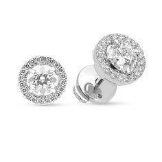 A special look, these diamond stud earrings elevate her attire. Crafted in cool 18K white gold, each earring features a 0.50ct. brilliant cut diamond - artfully set to enhance size and sparkle - wrapped in a stepped frame of smaller diamonds. Shimmering with 1.27 ct. t.w. of diamonds and a brilliant buffed luster, these post earrings secure comfortably with a protector squeeze back. 
0.51 carat E VS2
0.52  carat E SI1
0.24 carat diamonds pave setting
18k white gold Dazzling White Diamond Earrings With Pave Setting, Dazzling White Round Diamond Earrings, Luxury Diamond Earrings With Pave Setting Round Cut, Luxury Round Cut Diamond Earrings With Pave Setting, Luxury Diamond Earrings With Pave Setting In Round Cut, Fine Jewelry White Diamond Earrings With Halo, Luxury Platinum Diamond Earrings With Halo Design, White Diamond Halo Earrings In Fine Jewelry Style, White Diamond Halo Earrings Fine Jewelry