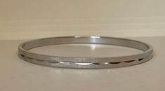 "Monet silver plated bangle bracelet  Excellent condition  diameter - 2 3/4\" x 3/16\" w.  marked: copyright symbol  Monet XL  03/24/23 1097" Adjustable Stainless Steel Bangle With Polished Finish, Adjustable Shiny Round Jewelry, Silver Stainless Steel Bangle With Polished Finish, White Gold Stainless Steel Bangle Cuff Bracelet, White Gold Stainless Steel Cuff Bangle, Formal Stainless Steel Bangle With Polished Finish, White Gold Stainless Steel Cuff Bracelet, White Gold Stainless Steel Bangle, Classic Silver Metal Bangle