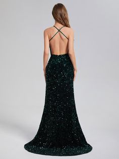 the back of a woman's dress with sequins on it, in dark green