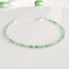 "Minimalist, wearable and delicate 925 sterling silver green emerald bracelet for everyday wearing. Length: from 5,5\" to 8\" with 2\" 925 sterling silver extensor chain. Width: 2 mm 925 sterling silver beads and green emerald beads. Material: 925 sterling silver strong lobster clasp. Handmade in Spain. ✩ Please kindly note that these stones are natural so they can vary slightly in color from the one on the pics. They can also contain some inclusions. ✩ Ideal for a gift to silver jewelry lovers. Green Emerald Bracelet, Layered Bracelet, Emerald Bracelet, Gold Armband, Emerald Bead, Birthstone Bracelet, Bracelet Crystal, Bracelet Dainty, Bracelet Gemstone