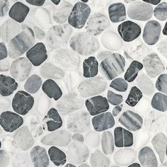 black and white pebbles are arranged on a marble flooring pattern in shades of gray