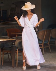 A linen maxi dress, featuring a plunging V-neck and elegant draped front. Elbow-length subtle ruffled sleeves and adjustable front cross belt offer a custom fit, while side slits add a graceful flow. Perfect for making a grand statement. With ruffled sleeves for a touch of romance, our white option is perfect as a linen wedding dress. • Tie-waist fit • Maxi-length • V-neck • Multi-way belt wrapping • Flared elbow-length sleeves Elegant V-neck Linen Dress For Beach, Elegant Linen V-neck Maxi Dress, Elegant White Linen V-neck Dress, Casual White V-neck Linen Dress, White Linen V-neck Maxi Dress, Linen Wedding Dress, Wrinkled Clothes, Elegant Drapes, Guest Attire