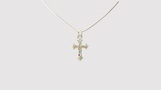 Our Heather collection contains all of our women's jewelry. Made from stainless steel, this necklace is intended to be as powerful as the woman wearing it. Each component is quality checked 10 times over, to ensure that each piece has the durability we promise it does. Each of the cross necklaces contains a cross with an accent, this specific one being wrapped in a vine, symbolizing that even when we feel restrained or restricted, the cross prevails without boundaries. This product is handcrafte Adjustable Sterling Silver Cross Pendant Jewelry, Adjustable Sterling Silver Cross Pendant, Dainty Silver Crucifix Necklace, Dainty Silver Crucifix Jewelry, Spiritual Stainless Steel Cross Pendant Necklaces, Spiritual Metal Cross Necklaces, Stainless Steel Crucifix Necklace With Adjustable Chain, Spiritual Silver Snake Chain Jewelry, Silver Spiritual Snake Chain Jewelry