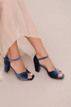 Add a touch of sophistication to your special day with the Kore, our latest addition to our shoe collection. This exquisite dusty blue sandal is crafted from luxurious velvet and lined with soft, supple leather for a sumptuous feel. The squared toe and butterfly-shaped toe strap add a touch of elegance, while the sturdy block heel and padded insole ensure that you can dance the night away in comfort and style. The Kore's understated design makes it the perfect match for any wedding dress, whethe Blue Bridal Shoes Heels & Wedges, Bridesmaid Open Toe Heels With 4-inch Heel, Blue Open Toe Sandals For Prom, Elegant Blue Sandals With 4-inch Heel, Elegant Blue Block Heels For Formal Occasions, Blue Low Heel Sandals For Wedding, Blue Open Toe Sandals For Wedding, Open Toe Blue Sandals For Wedding, Blue Open Heel Wedding Shoes For Evening