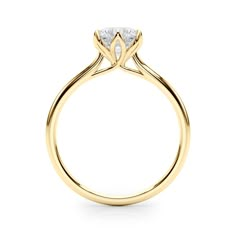 a yellow gold engagement ring with a single diamond in the center, on a white background