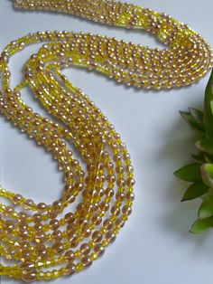 Double Strand Waist Bead, featuring vibrant yellow crystal glass beads with elegant brown and gold accents. Why You'll Love It: Radiant Shine: Beautiful yellow crystal glass beads offer a lively, eye-catching sparkle. Elegant Accents: Brown and gold crystal glass beads add a touch of sophistication and warmth. Perfect Fit: The adjustable double strand design ensures a comfortable and secure fit for all body types. Cultural Elegance: This piece captures the rich heritage of Ivorian craftsmanship, blending traditional beauty with modern flair. Color Significance: Yellow: In Ivorian culture, yellow symbolizes happiness, energy, and vitality. Wearing yellow beads can uplift your spirit and bring a sense of joy and warmth. Brown: Brown represents the earth, stability, and reliability. It adds g Gold Beaded Necklaces For Jewelry Making, Gold Multi-strand Beaded Necklaces With Faceted Beads, Gold Round Beaded Necklaces For Party, Gold Beads With Beaded Chain For Party, Gold Beaded Chain Beads For Party, Gold Beaded Necklace For Parties, Gold Necklaces With Colorful Beads For Party, Gold Necklaces With Spacer Beads For Party, Gold Beaded Chain For Party