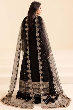 Elegant Embellished Black Pakistani Wedding Dress in Pishwas Style perfectly balances style and elegance. This perfectly stitched Pishwas Dress is perfect for a trendy look on the big day. Hand-crafted details of embellishments give a glamorous touch to this Pakistani Dress. Detailed Description: SKU: WB400 Detailing: Embroidery, Motifs, Naqshi, Sequins, Dabka, Crystals, Pearls, Zardosi Color: Black Fabric: Silk, Net, Organza Design: Fully Embellished Dress with Embroidery and Silverwork Event: Black Embellished Organza Sets, Embellished Black Organza Sets, Festive Black Organza Gown, Black Organza Sharara For Reception, Black Organza Dress With Traditional Drape, Black Embellished Organza Dupatta, Embellished Black Sharara For Eid, Elegant Black Organza Lehenga, Black Organza Party Dress