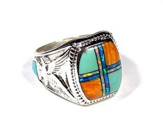 "Brand new high quality 925 sterling silver handcrafted men's ring with Genuine Turquoise, Fire Opal & Spiny Oyster shell inlaid on solid 925 sterling silver. The width measures 11/16\" (17mm). There is a silver Eagle and a Turquoise stone inlaid on the sides of the ring shank. The ring weighs 11 grams. Our silver is genuine 925 sterling silver. You will receive the exact item in a gift box. Thanks for looking and check out more items in my Etsy shop for more great items and deals! https://w Sterling Silver Inlay Jewelry, Men’s Turquoise Ring, Fire Opal Mens Ring, Luxury Men's Turquoise Ring With Polished Finish, Luxury Polished Turquoise Men's Ring, Luxury Men's Sterling Silver Turquoise Ring, Mens Turquoise Rings, Stone Rings For Men, Jewlery Rings