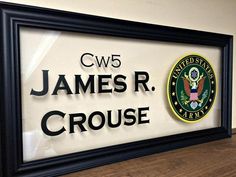 a framed plaque with the name and seal of james r crouse in black frame