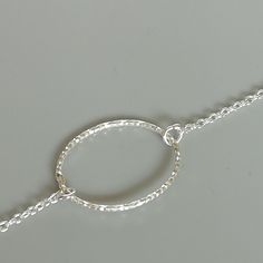 Sterling silver chain bracelet with an oval ring charm. Length: 6.8 to 7.8 inches Oval charm: 13 x 17 mm Weight: 1 gm This bracelet is made of 925 hypoallergenic sterling silver. Can be packaged in a gift box. I can include a personal message from you if needed You are welcome to contact me at... bhavnakwintra1956@gmail.com For more beautiful pieces from my shop, please browse 👇 TOE RINGS: https://www.etsy.com/your/shops/TheSilverGame/tools/listings/section:27020628,view:table EAR HOOPS: https: Silver Minimalist Bracelet With Lobster Clasp, Minimalist Silver Bracelet With Lobster Clasp, Adjustable Delicate Sterling Silver Bracelet As A Gift, Minimalist Silver Metal Charm Bracelet, Minimalist Adjustable Sterling Silver Bracelet With Lobster Clasp, Simple Adjustable Sterling Silver Bracelet, Silver Minimalist Charm Bracelet, Simple Handmade Silver Bracelets, Delicate Silver Chain Bracelet As Gift