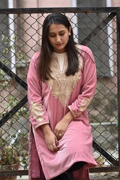 Style up with this elegant velvet kurta with Kashmiri Tilla embroidery. Pair this Tunic Top Kurta with a skirt, trousers, jeans, jeggings, dhoti or any other bottom and be ready in style.- - - - - - - - - - - - - - - - - - - - Product DetailsVelvet Kurta with Kashmiri Tilla Embroidery (Metallic Thread)- Condition: Brand New (Made to Order)- Fabric: Fine Velvet- Fully Lined from Inside- Features Pockets on both sides.- Colour: Peach- Length: 40" (102 cms approx, the mannequin is 6ft tall).- Care Kashmiri Kurta Woman, Kashmiri Outfits For Women, Embroided Dresses, Kashmiri Kurti, Kashmiri Tilla Embroidery Suits, Kashmiri Kurta, Tilla Designs Kashmiri Pheran, Embroidery Metallic, Kashmiri Tilla Embroidery