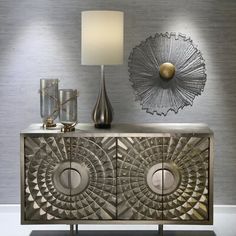 a silver sideboard with two lamps and a lamp shade