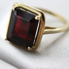 An Absolutely gorgeous Red Garnet Gold ring. Featuring a Prong set 6.5 Carat 10 x 12 Red Garnet natural Gemstone. The color is simply amazing as well as the clarity, This is a Grade AAA corundum Gemstone. When i saw the beauty of this gemstone i had to have it, I simply had to buy a few and make a few rings with them i could not escape its beauty! Each ring is hand made to your order from start to finish with the utmost attention to details, service and finish. We only have a few of these marvel Formal Garnet Ring With Center Stone, Formal Garnet Rings Fine Jewelry, Classic Red Sapphire Promise Ring, Formal Ruby Ring, Formal Red Sapphire Ring, Red Emerald-cut Ring For Gift, Emerald Cut Red Ring For Gift, Formal Garnet Gemstone Diamond Ring, Red Diamond Birthstone Ring For Formal Occasions