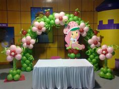 a table with balloons and decorations on it