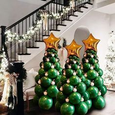 christmas tree made out of balloons in front of stairs