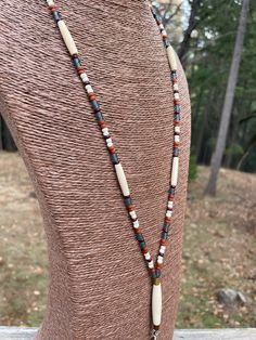 the necklace is made with beads and wooden beads on a mannequin dummy's neck