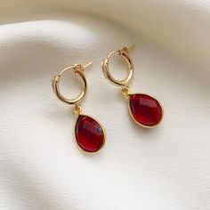 Beautiful garnet pear shape bezel-set gemstones dangle from 14k gold fill click style hoop earrings.  Garnet is the birthstone for January and symbolizes inner force, passion, and love.  These simple earrings make a lovely gift for loved ones born in January or for fans of this beautiful hue. If you are looking for this style in other colors, they are available in gemstones for all the months of the year in my shop.   ✤Hoops: 13mm diameter ✤Gemstone Charms: 18.5x11.5mm Stone diameter: 14 x 10mm Tarnish Resistant Teardrop Pendant Earrings As Gift, Tarnish Resistant Teardrop Pendant Earrings, Fine Jewelry Teardrop Gemstone Hoop Earrings, Teardrop Gemstone Hoop Earrings In Fine Jewelry Style, Single Pear-shaped Teardrop Earring As Gift, Fine Jewelry Teardrop Pendant Earrings As Gift, Fine Jewelry Teardrop Hoop Earrings As Gift, Round Gemstone Teardrop Earrings For Anniversary, Round Teardrop Gemstone Earrings For Anniversary